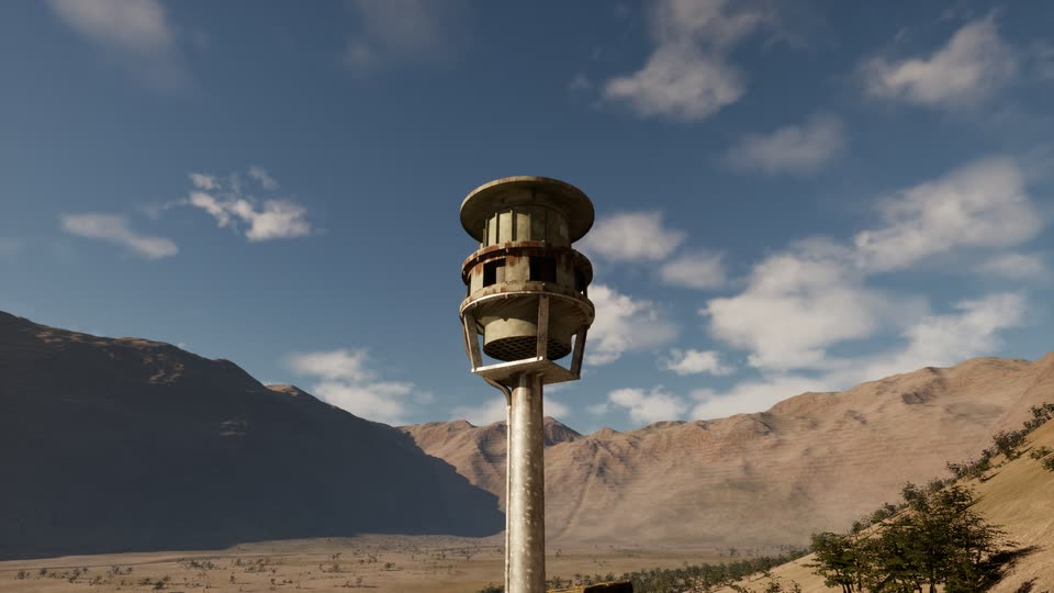 A weathered civil-defense siren on a tall pole seen from below, against a blue sky with clouds and the valley's brown ridges.