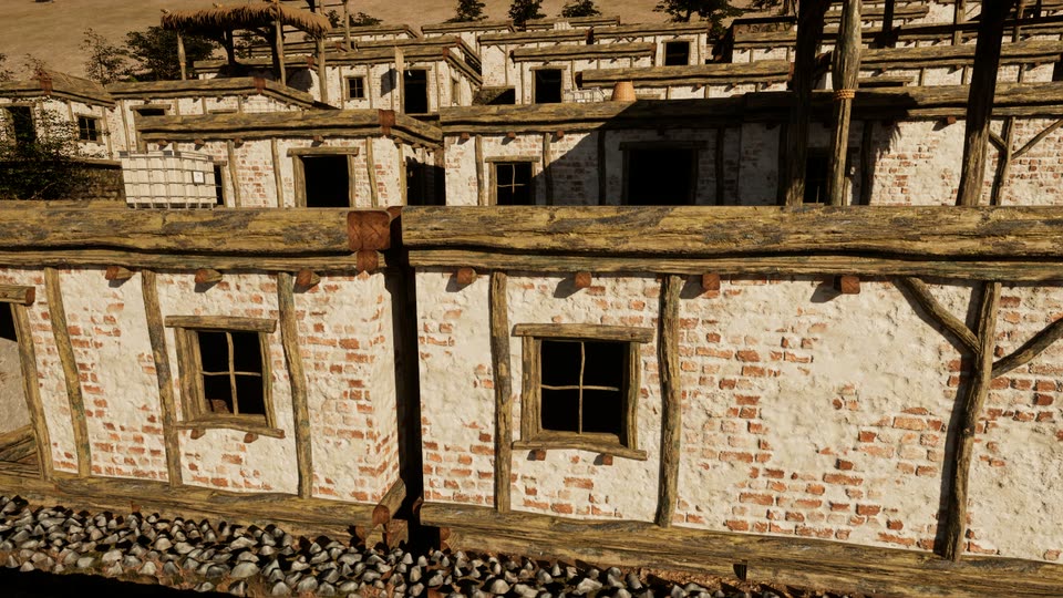 Whitewashed masonry walls, brick showing where the plaster has worn, with timber framing, small wooden windows and beam ends above a stone-edged lane.